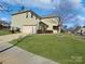 Side view of a two-story house with light green siding and a driveway at 15305 Colonial Park Dr, Huntersville, NC 28078