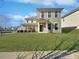 Two-story house with light green siding and a manicured lawn at 15305 Colonial Park Dr, Huntersville, NC 28078