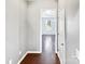 Hallway with light grey walls and dark hardwood floors at 15305 Colonial Park Dr, Huntersville, NC 28078