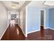 Hardwood floor hallway with light blue walls and access to other rooms at 15305 Colonial Park Dr, Huntersville, NC 28078