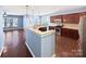 Modern kitchen with granite countertops and dark wood cabinets at 15305 Colonial Park Dr, Huntersville, NC 28078