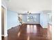 Spacious living room with hardwood floors, neutral walls, and a ceiling fan at 15305 Colonial Park Dr, Huntersville, NC 28078