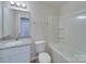 Clean bathroom with a white bathtub and granite vanity at 162 Four Andrews Dr, Harmony, NC 28634