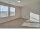 Well-lit bedroom with two windows and carpet at 162 Four Andrews Dr, Harmony, NC 28634