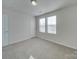 Bedroom with two windows, carpet, and door to hallway at 162 Four Andrews Dr, Harmony, NC 28634