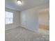 Spacious bedroom with gray carpet and access to another room at 162 Four Andrews Dr, Harmony, NC 28634