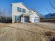 Two-story house with gray siding, blue door, and a spacious front yard at 162 Four Andrews Dr, Harmony, NC 28634