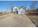 Two-story house with gray siding, a two-car garage, and a long driveway at 162 Four Andrews Dr, Harmony, NC 28634