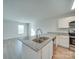 Modern kitchen with island, granite countertops, and stainless steel appliances at 162 Four Andrews Dr, Harmony, NC 28634