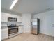 Bright kitchen featuring stainless steel appliances and white cabinets at 162 Four Andrews Dr, Harmony, NC 28634