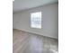 Bright and airy living room with light gray floors and a large window at 162 Four Andrews Dr, Harmony, NC 28634