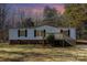 White mobile home with deck, landscaped yard, and wooded backdrop at 1762 Proposal Ave, Chester, SC 29706