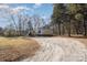 Mobile home with gravel driveway and wooded surroundings at 1762 Proposal Ave, Chester, SC 29706