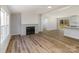 Bright living room with hardwood floors, fireplace, and sliding glass doors to a deck at 1762 Proposal Ave, Chester, SC 29706