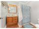 Bathroom with wood vanity, tiled floor and shower at 182 Grand View Dr, New London, NC 28127