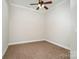 Carpeted bedroom with ceiling fan and neutral walls at 182 Grand View Dr, New London, NC 28127