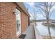 Deck overlooks lake with brick wall and door at 182 Grand View Dr, New London, NC 28127