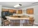 Kitchen features wood cabinets, black appliances, and a breakfast bar at 182 Grand View Dr, New London, NC 28127