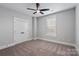 Bedroom features neutral walls, plush carpet, a ceiling fan, a large window, and double doors at 1852 Yardley St, Rock Hill, SC 29732