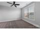 Bright bedroom featuring neutral walls, plush carpet, a ceiling fan, and a large window at 1852 Yardley St, Rock Hill, SC 29732