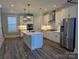 Modern kitchen featuring white cabinets, a large island, and stainless steel appliances at 1852 Yardley St, Rock Hill, SC 29732