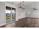 Living room features sliding glass doors to the back yard, modern light fixture, and hardwood floors at 1852 Yardley St, Rock Hill, SC 29732