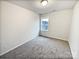 Bright bedroom with gray carpeting and a window at 1924 Felts Pkwy, Fort Mill, SC 29715