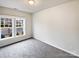 Simple bedroom with gray carpet and a large window at 1924 Felts Pkwy, Fort Mill, SC 29715