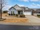 Two-story house with blue siding, stone accents, and a three-car garage at 1924 Felts Pkwy, Fort Mill, SC 29715