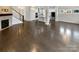 Hardwood floor living area with an open floor plan and a fireplace at 1924 Felts Pkwy, Fort Mill, SC 29715