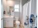 Simple bathroom with toilet, sink, and shower at 201 Picasso Trl, Mount Holly, NC 28120