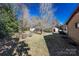 Spacious backyard with mature trees and a shed, offering privacy and storage at 202 Cedar St, Belmont, NC 28012