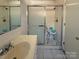 Bathroom featuring a shower with doors, sink and a mirror at 202 Cedar St, Belmont, NC 28012