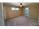 Bedroom featuring beige walls, stained carpet and a ceiling fan at 202 Cedar St, Belmont, NC 28012