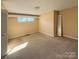 Bedroom featuring beige walls, stained carpet and a window at 202 Cedar St, Belmont, NC 28012