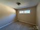 Bedroom featuring beige walls, stained carpet and a window at 202 Cedar St, Belmont, NC 28012