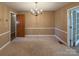 Dining room with beige walls, stained carpet and a chandelier at 202 Cedar St, Belmont, NC 28012