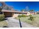 Single-story home with a convenient carport and manicured landscaping at 202 Cedar St, Belmont, NC 28012