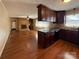 Open-concept kitchen connected to the living room with dark wood cabinets and granite countertops at 202 Cedar St, Belmont, NC 28012