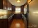 Kitchen showcasing stainless steel appliances, dark wood cabinets, and granite countertops at 202 Cedar St, Belmont, NC 28012