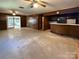 View of the living room with an adjoining bar area and brick fireplace in the distance at 202 Cedar St, Belmont, NC 28012