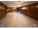 Large recreation room featuring wood paneling, built-in seating, and ceiling fans at 202 Cedar St, Belmont, NC 28012