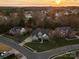 Aerial view of the neighborhood showcasing a well-maintained brick home in a beautiful setting at sunset at 209 Choate Ave, Fort Mill, SC 29708