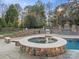 Resort-style backyard featuring a pool, hot tub, built-in grill, and a pergola-covered dining area for premier outdoor enjoyment at 209 Choate Ave, Fort Mill, SC 29708