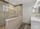 Modern bathroom features a glass enclosed shower with wood-look tile and built in shower niches at 209 Choate Ave, Fort Mill, SC 29708