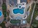 Aerial view of backyard pool with spa, putting green, patio, outdoor kitchen, and professional landscaping at 209 Choate Ave, Fort Mill, SC 29708