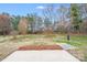 Spacious backyard with mature trees, partially fenced, offering ample room for outdoor activities at 2213 Genesis Dr, Monroe, NC 28110