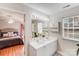 Charming bathroom offering a double sink, medicine cabinet, and view to a neutral bedroom at 2213 Genesis Dr, Monroe, NC 28110