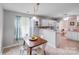 Breakfast nook features wood table, white chairs, and kitchen views at 2213 Genesis Dr, Monroe, NC 28110