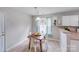 Cozy dining area features a wood table, white chairs, and built-in shelves at 2213 Genesis Dr, Monroe, NC 28110